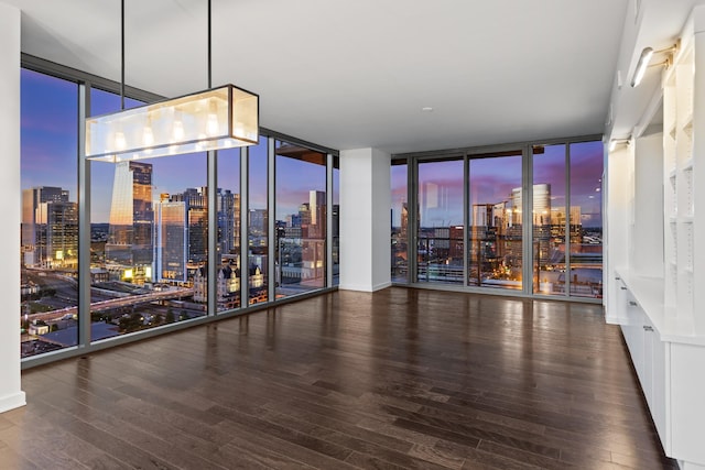 1212 Laurel St Unit 1902, Nashville, TN 37203 - empty room with expansive windows, a view of skyline, hardwood / wood-style floors, and a bar