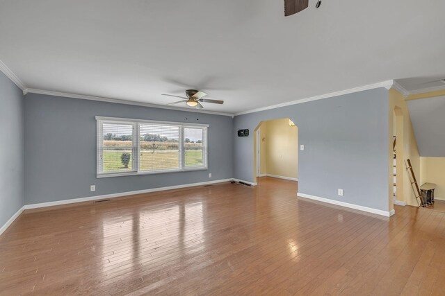 135 Carter Rd, Winchester, TN 37398 - spare room featuring a ceiling fan, crown molding, arched walkways, wood finished floors, and baseboards