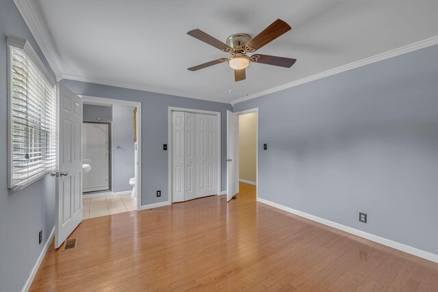 135 Carter Rd, Winchester, TN 37398 - unfurnished bedroom featuring baseboards, crown molding, light wood-style flooring, connected bathroom, and a closet