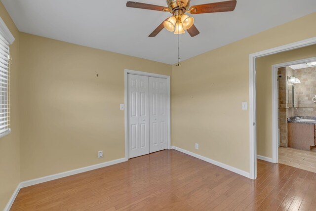 135 Carter Rd, Winchester, TN 37398 - unfurnished bedroom with wood finished floors, baseboards, a closet, and a ceiling fan