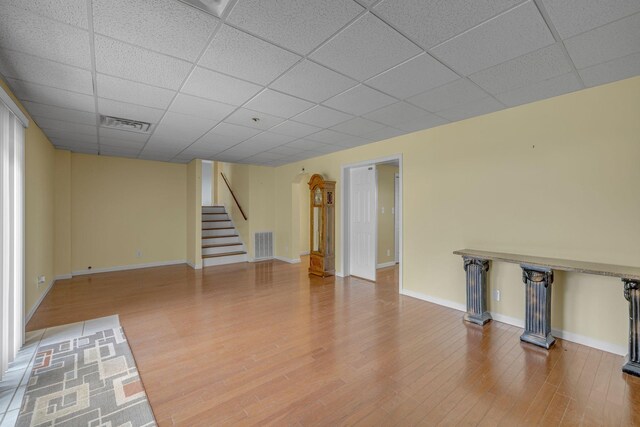 135 Carter Rd, Winchester, TN 37398 - unfurnished living room with a drop ceiling, stairs, wood finished floors, and baseboards