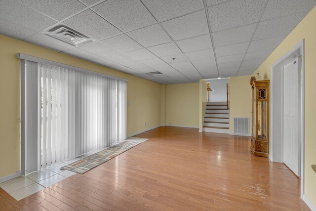 135 Carter Rd, Winchester, TN 37398 - spare room featuring wood finished floors, a paneled ceiling, healthy amount of natural light, stairway, and baseboards