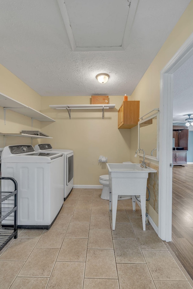 135 Carter Rd, Winchester, TN 37398 - laundry room with washer and clothes dryer, a textured ceiling, baseboards, and light tile patterned floors