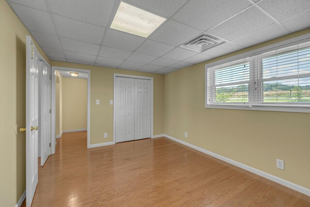 135 Carter Rd, Winchester, TN 37398 - unfurnished bedroom with a paneled ceiling, light wood finished floors, a closet, and baseboards