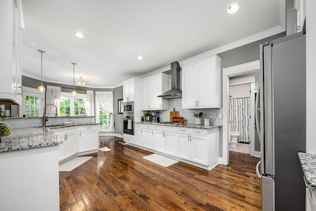 541 Piccadilly Dr, Murfreesboro, TN 37128 - kitchen with wall chimney range hood, appliances with stainless steel finishes, crown molding, white cabinets, and tasteful backsplash