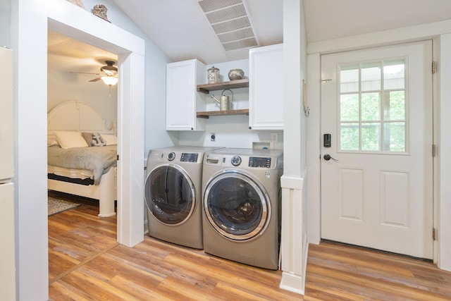 91 Creekside View Ln, Decaturville, TN 38329 - washroom with cabinet space, washer and clothes dryer, a ceiling fan, and light wood finished floors
