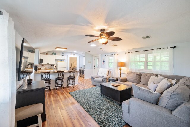 91 Creekside View Ln, Decaturville, TN 38329 - living area with washer / dryer, ceiling fan, light wood-type flooring, and lofted ceiling