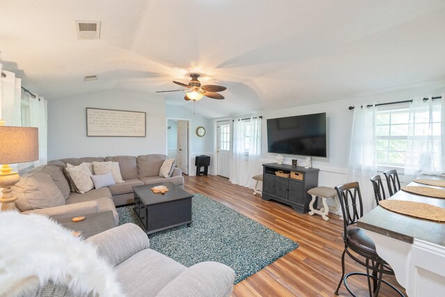 91 Creekside View Ln, Decaturville, TN 38329 - living area featuring a ceiling fan, lofted ceiling, wood finished floors, and a wainscoted wall