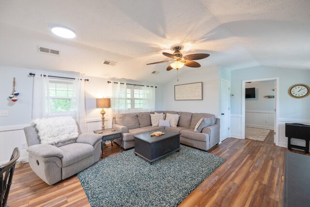 91 Creekside View Ln, Decaturville, TN 38329 - living room featuring vaulted ceiling, ceiling fan, wainscoting, wood finished floors, and healthy amount of natural light