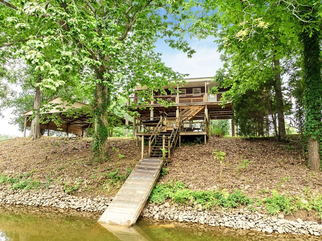 91 Creekside View Ln, Decaturville, TN 38329 - back of property featuring stairs and a deck with water view