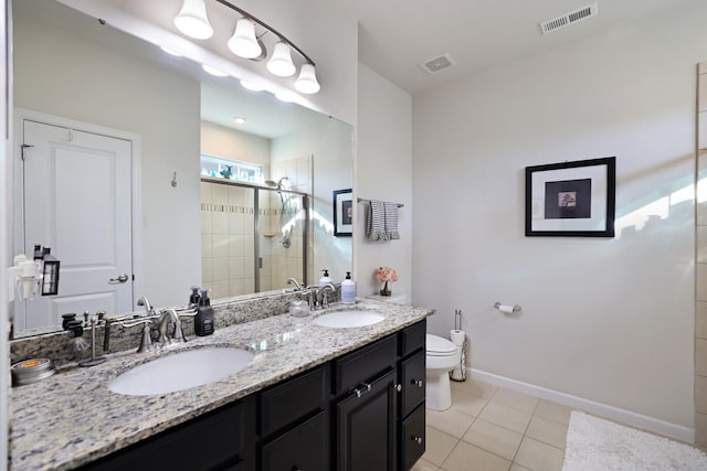 2844 Bluestem Ln, Murfreesboro, TN 37128 - bathroom featuring toilet, double vanity, a shower stall, baseboards, and tile patterned flooring