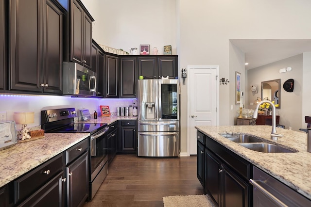 2844 Bluestem Ln, Murfreesboro, TN 37128 - kitchen featuring stainless steel appliances, a sink, dark wood-type flooring, and light stone counters