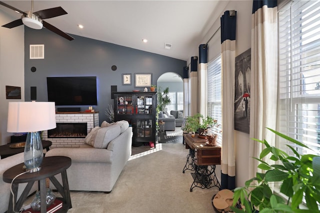 2844 Bluestem Ln, Murfreesboro, TN 37128 - living room with arched walkways, ceiling fan, lofted ceiling, carpet, and a brick fireplace