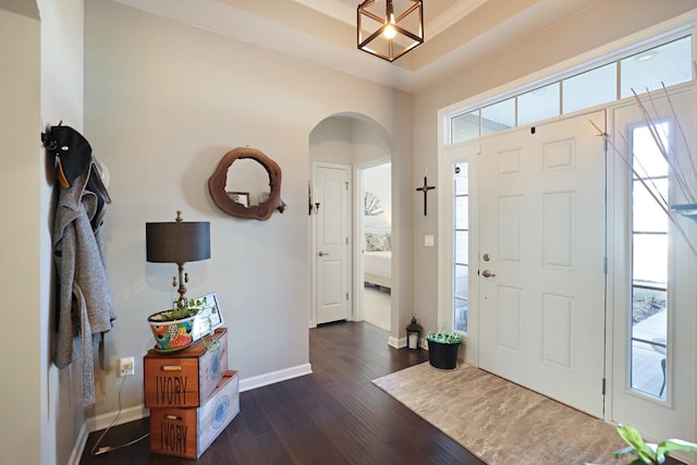 2844 Bluestem Ln, Murfreesboro, TN 37128 - foyer featuring arched walkways, dark wood finished floors, baseboards, and a chandelier