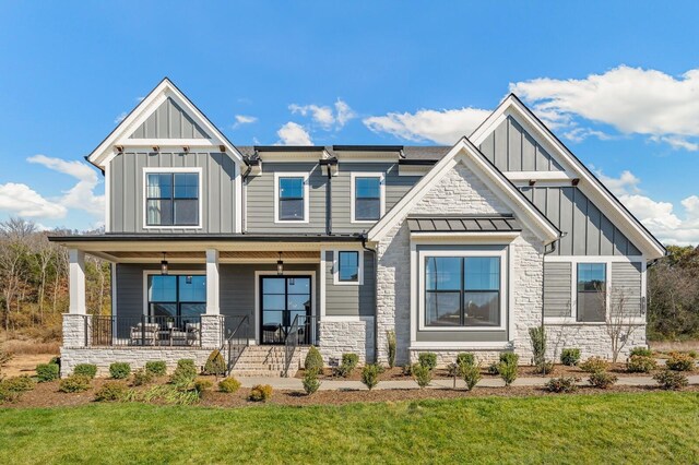 7286 Murrel Dr, Franklin, TN 37064 - craftsman house featuring board and batten siding, stone siding, covered porch, and a front lawn