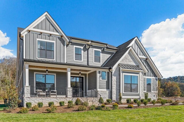 7286 Murrel Dr, Franklin, TN 37064 - craftsman-style home featuring board and batten siding, covered porch, stone siding, and a front yard