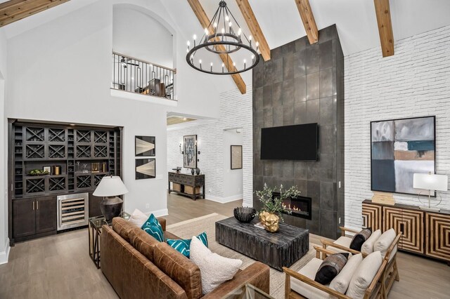7286 Murrel Dr, Franklin, TN 37064 - living area with high vaulted ceiling, a bar, wood finished floors, baseboards, and beamed ceiling