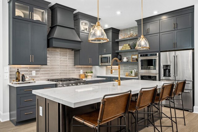 7286 Murrel Dr, Franklin, TN 37064 - kitchen featuring appliances with stainless steel finishes, custom exhaust hood, a sink, light wood finished floors, and recessed lighting