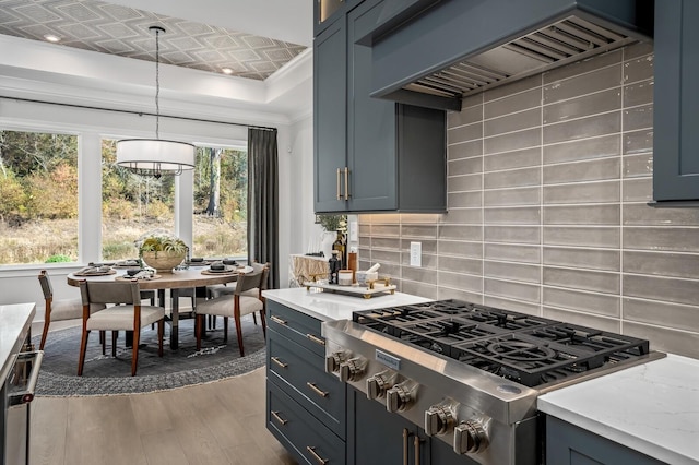 7286 Murrel Dr, Franklin, TN 37064 - kitchen with stainless steel gas stovetop, custom exhaust hood, wood finished floors, tasteful backsplash, and pendant lighting
