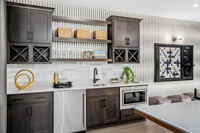 7286 Murrel Dr, Franklin, TN 37064 - bar area featuring fridge, stainless steel microwave, a sink, light wood finished floors, and wallpapered walls