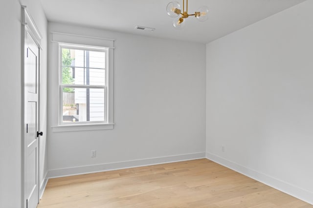 1712 Carvell Ave, Nashville, TN 37203 - spare room with a chandelier, light wood finished floors, and baseboards