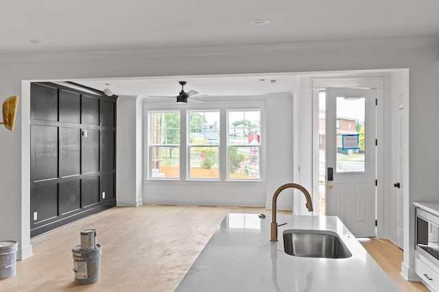 1712 Carvell Ave, Nashville, TN 37203 - kitchen with a sink, crown molding, stainless steel microwave, a ceiling fan, and light countertops