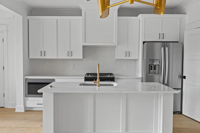1712 Carvell Ave, Nashville, TN 37203 - kitchen with stainless steel fridge, a sink, light wood finished floors, backsplash, and white cabinets