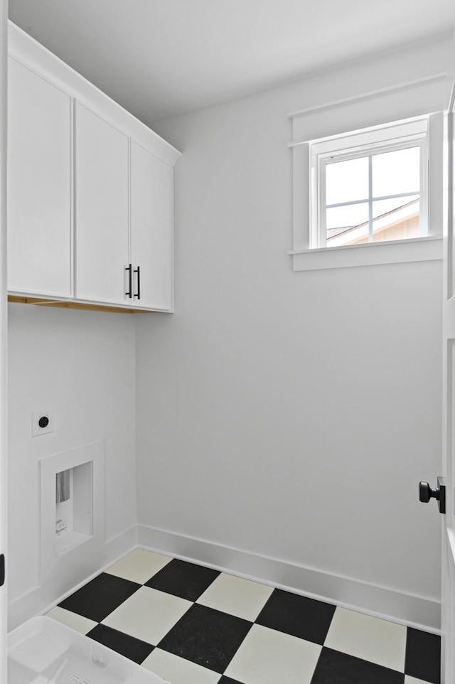 1712 Carvell Ave, Nashville, TN 37203 - laundry room featuring cabinet space, tile patterned floors, electric dryer hookup, and baseboards