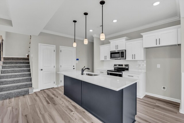 752 Boreal Way, Clarksville, TN 37042 - kitchen with appliances with stainless steel finishes, a sink, light wood-style floors, white cabinetry, and an island with sink