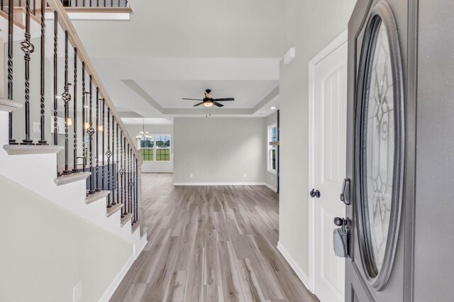 752 Boreal Way, Clarksville, TN 37042 - foyer with light wood finished floors, a raised ceiling, a chandelier, baseboards, and stairs