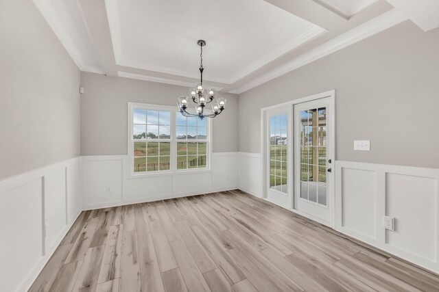 752 Boreal Way, Clarksville, TN 37042 - unfurnished dining area with wainscoting, a chandelier, a tray ceiling, light wood finished floors, and a decorative wall