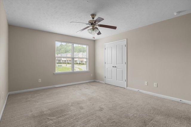 4316 Summercrest Blvd Unit 105, Antioch, TN 37013 - unfurnished bedroom featuring carpet floors, a closet, baseboards, a textured ceiling, and a ceiling fan