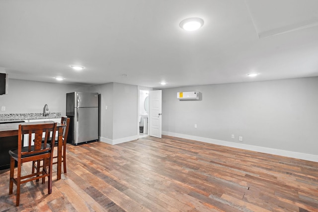 129 Neese Dr, Nashville, TN 37211 - kitchen with freestanding refrigerator, a wall mounted air conditioner, light countertops, wood finished floors, and baseboards