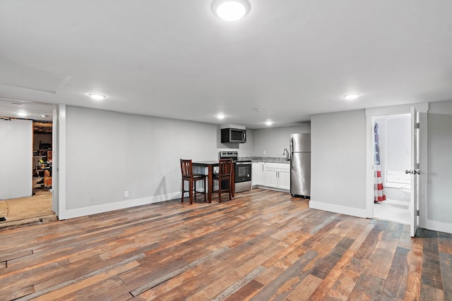 129 Neese Dr, Nashville, TN 37211 - kitchen with appliances with stainless steel finishes, dark wood-type flooring, light countertops, baseboards, and recessed lighting