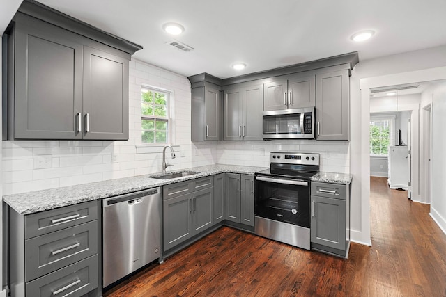 129 Neese Dr, Nashville, TN 37211 - kitchen featuring appliances with stainless steel finishes, a sink, gray cabinetry, dark wood finished floors, and light stone counters