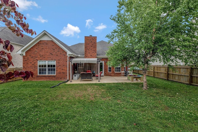 4047 Locerbie Cir, Spring Hill, TN 37174 - back of property with brick siding, a chimney, a patio area, and a fenced backyard