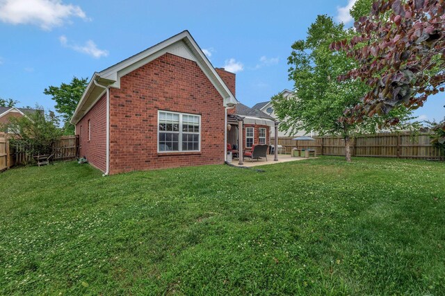 4047 Locerbie Cir, Spring Hill, TN 37174 - rear view of property featuring brick siding, a patio, and a fenced backyard