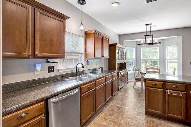 4047 Locerbie Cir, Spring Hill, TN 37174 - kitchen with stainless steel dishwasher, dark countertops, plenty of natural light, and decorative light fixtures