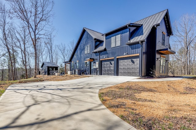 639 Piney Creek Rd, Hohenwald, TN 38462 - view of home's exterior with a standing seam roof, driveway, metal roof, and a garage