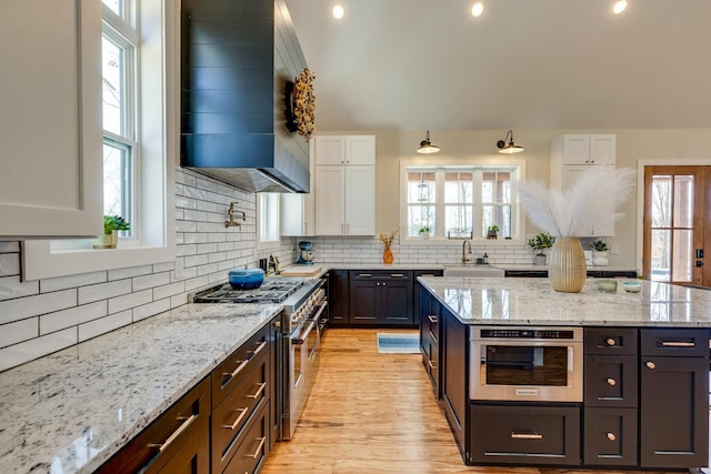 639 Piney Creek Rd, Hohenwald, TN 38462 - kitchen featuring stainless steel appliances, white cabinets, plenty of natural light, backsplash, and recessed lighting