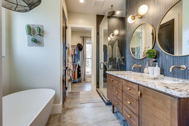 639 Piney Creek Rd, Hohenwald, TN 38462 - full bathroom with a freestanding bath, double vanity, concrete floors, a shower stall, and a walk in closet