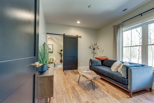 639 Piney Creek Rd, Hohenwald, TN 38462 - living area with a barn door, light wood-style floors, baseboards, and recessed lighting