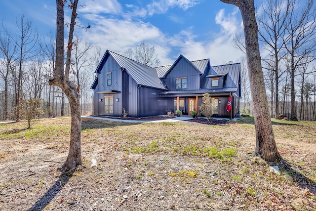 639 Piney Creek Rd, Hohenwald, TN 38462 - modern farmhouse style home featuring metal roof, a standing seam roof, and covered porch