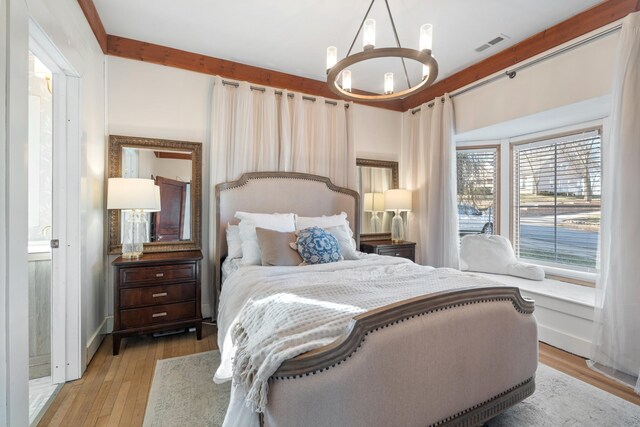 409 W 6th St, Columbia, TN 38401 - bedroom with a chandelier and light wood-style floors