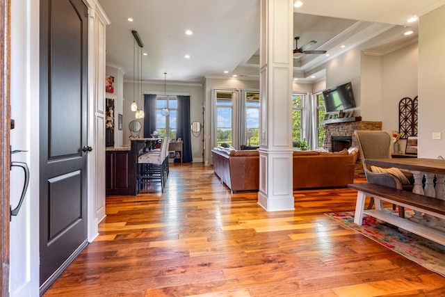 532 Tidwell Rd, Bon Aqua, TN 37025 - entryway with crown molding, healthy amount of natural light, light wood finished floors, a stone fireplace, and a ceiling fan