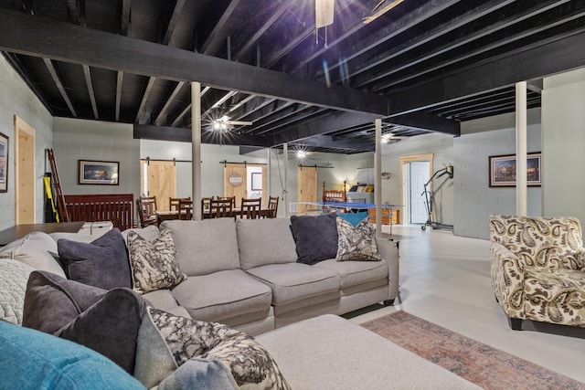532 Tidwell Rd, Bon Aqua, TN 37025 - living room featuring concrete flooring, a barn door, and concrete block wall