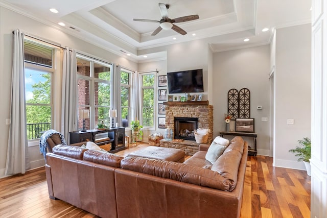 532 Tidwell Rd, Bon Aqua, TN 37025 - living room featuring light wood-style flooring, a ceiling fan, a raised ceiling, a fireplace, and baseboards