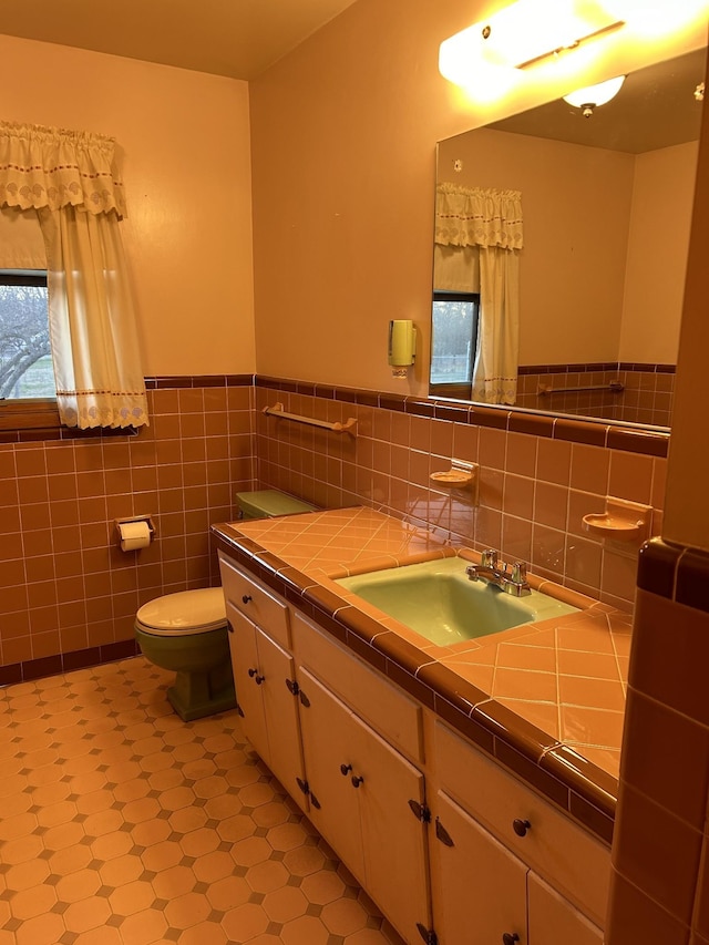 1409 Nashville Hwy, Columbia, TN 38401 - bathroom featuring vanity, toilet, tile patterned floors, wainscoting, and tile walls