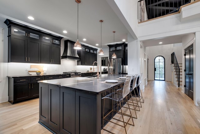 1050 Garton Rd, Burns, TN 37029 - kitchen with custom exhaust hood, appliances with stainless steel finishes, dark cabinets, a breakfast bar area, and recessed lighting