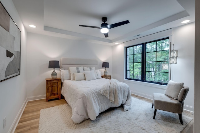 1050 Garton Rd, Burns, TN 37029 - bedroom with a tray ceiling, light wood-type flooring, recessed lighting, baseboards, and a ceiling fan